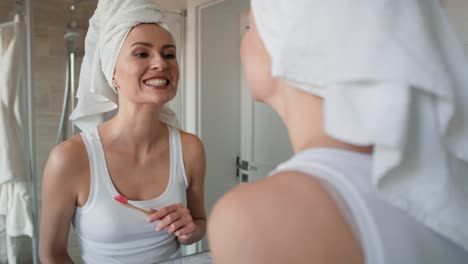 caucasian woman checking clean teeth right after brushing.