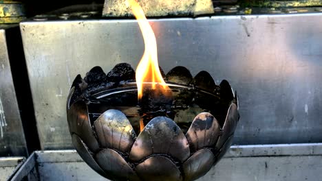 flame in silver metal lamp at wat phra that doi suthep, chiang mai, thailand