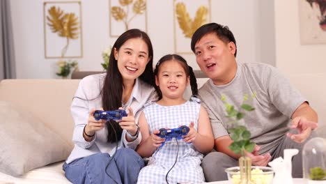 a family enjoys playing video games together on a couch, creating a warm and joyful atmosphere with bright lighting