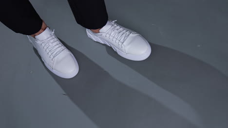 white sneakers on black pants
