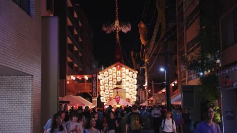 japanese festival at night with illuminated float and crowd