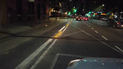 night drive pov car window's seat, traffic lights of cordoba avenue buenos aires city, argentine palermo neighborhood