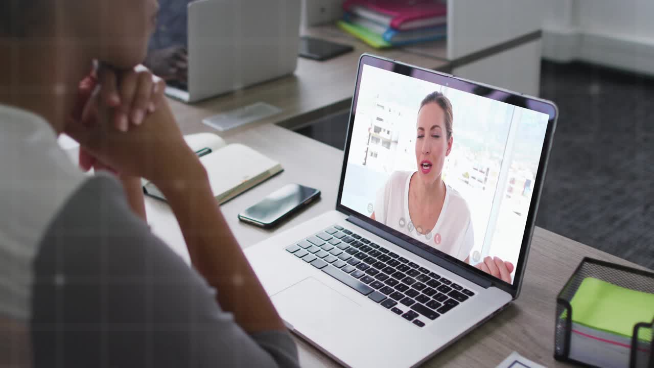 Viewer watching laptop as presenter starting grid overlay crossing screen and showing tech metrics