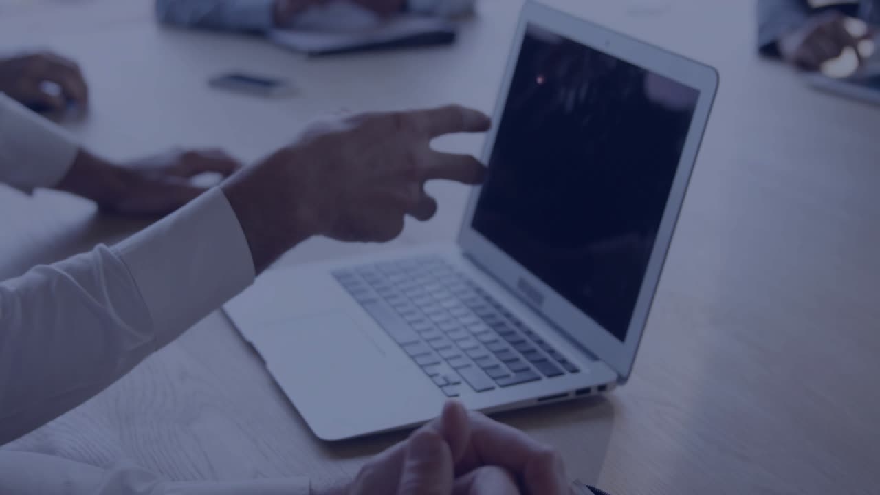 Presenter typing on laptop and gesturing at data panel after map overlay popping for insights