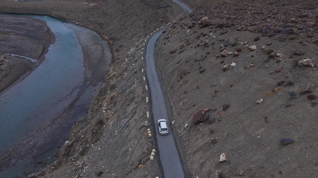 Mountain Road with Winding River and Car