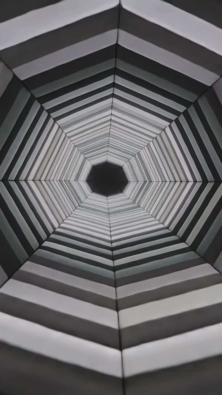 Vertical video: Scaling hexagon rings moving inward at art, creating illusion of depth into void