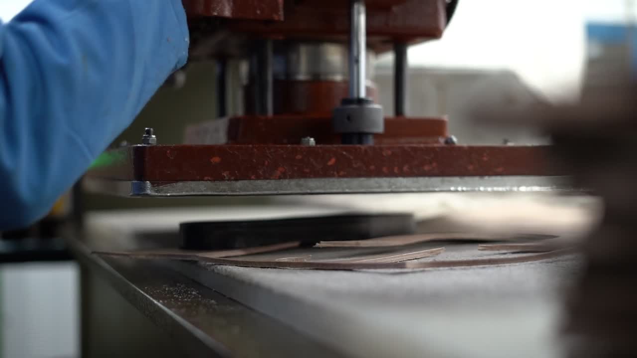 a craftsman handmade a bag by a machine, close up shot, insert shot