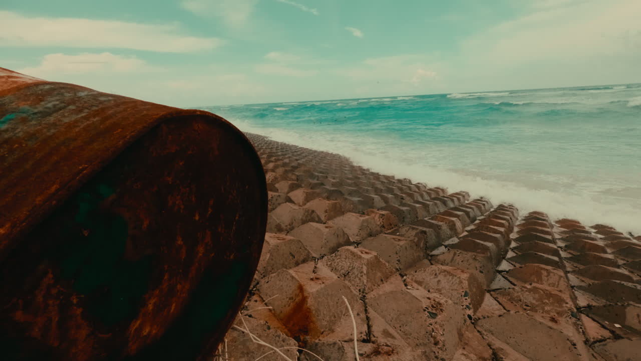 Rusty Barrel on a Beach Sea Wall