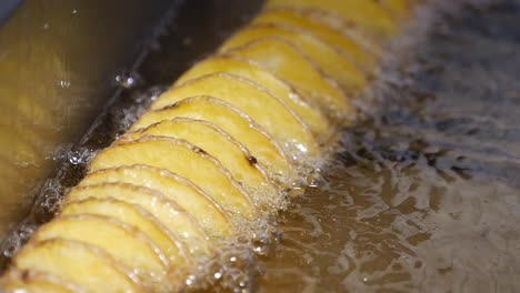 spiral potato fries being deep fried