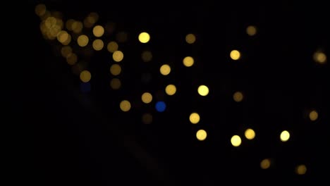 bokeh of lights of garlands. blurred soft focus. the garland is flashing. city lights at night. christmas mood