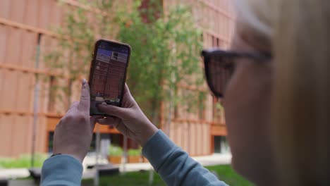 Unrecognizable-woman-taking-picture-of-the-city-building