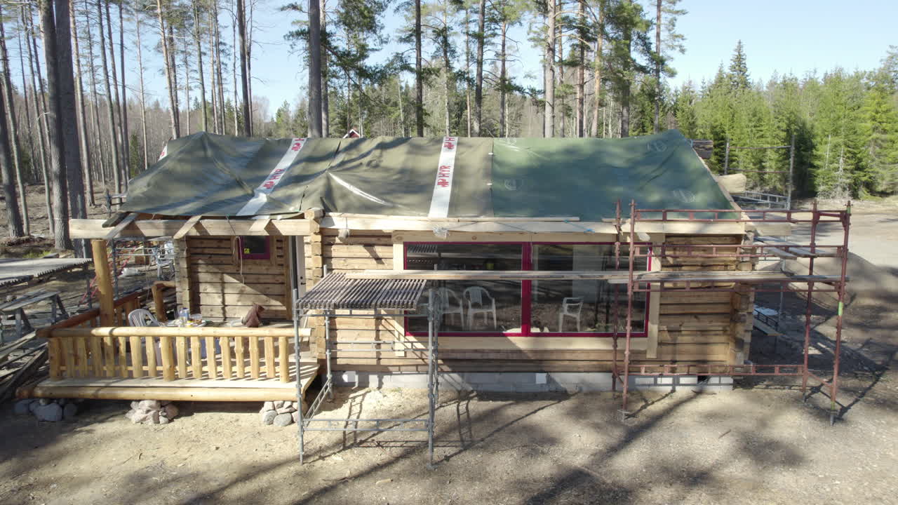 Construction of a log house in the woods.