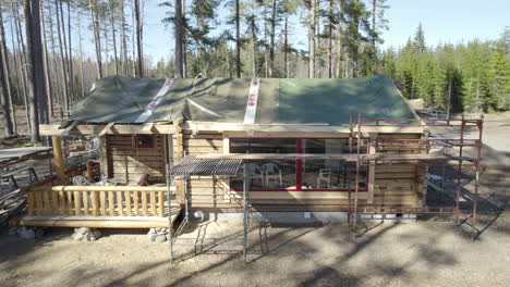 construction of a log house in the woods.