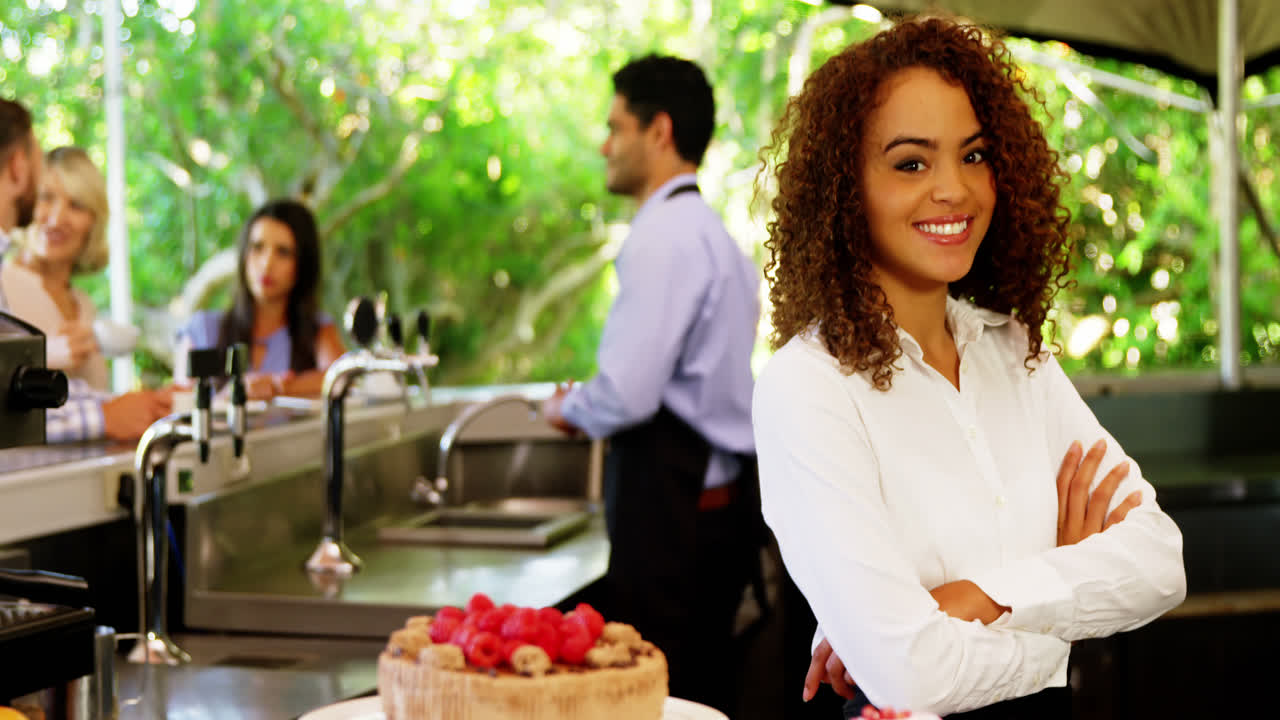 Female waitress standing with arms crossed