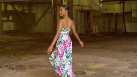 a young girl smiles while she spins in 360 multiple times at an abandoned warehouse