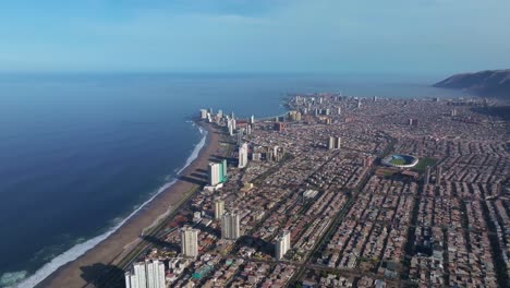 Aerial-rotating-shot-showing-the-large-skyscrapers-in-downtown-Iquique-and-beach