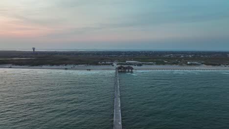 Bob-Hall-Pier-Into-The-Gulf-Of-Mexico-At-North-Padre-Island,-Texas---aerial-shot