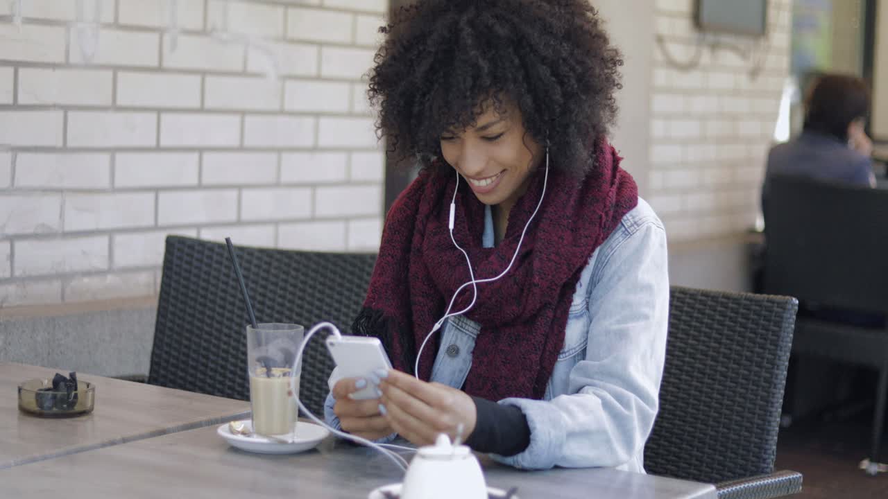 Charming girl with drink and smartphone