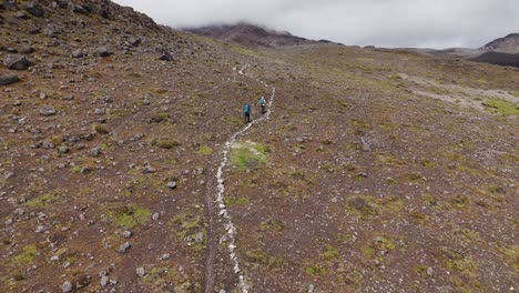 aerial view of hikers on the rugged rocks of mountains of ecuador