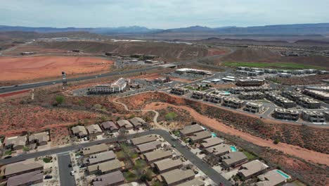 Aerial-View-of-Interstate-15-Highway-Traffic-by-Hurricane,-Utah-USA,-Residential-Suburbs-and-Landscape