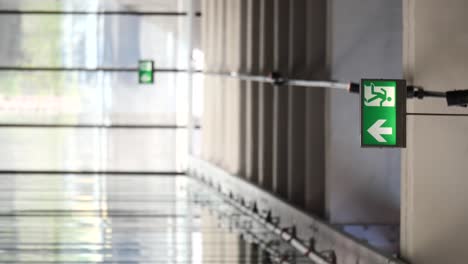 emergency exit signs in a building corridor