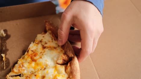 cheese pizza in a cardboard box close up.