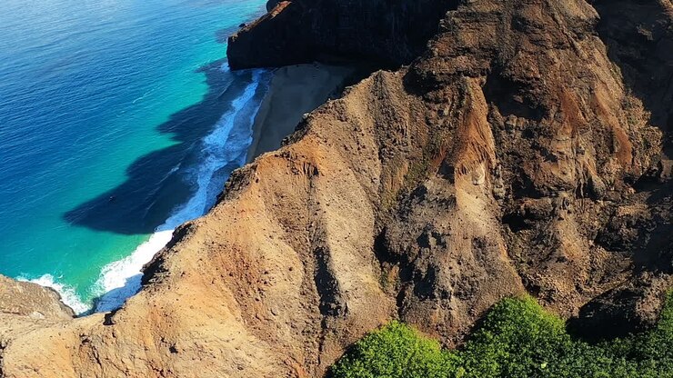 Aerial View of a Hawaiian Coastline Beach and Cliffs