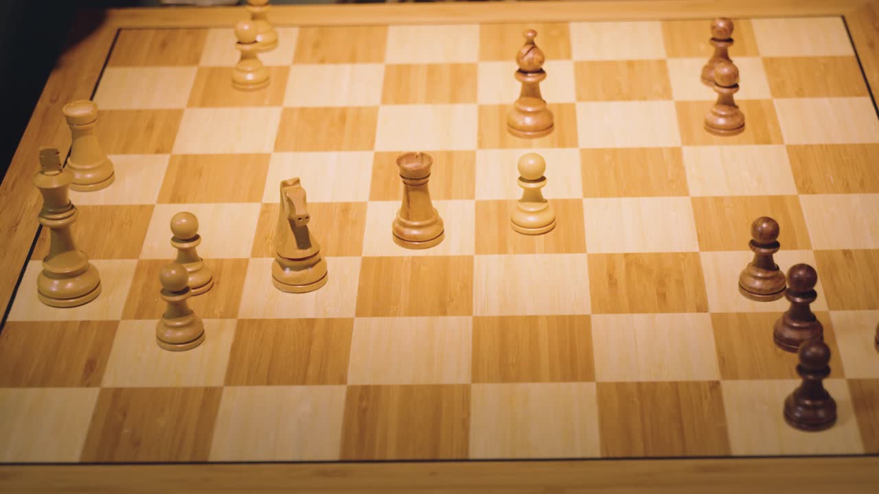 las manos de dos jugadores de ajedrez mueven las piezas alternativamente, sacando algunas piezas del tablero de ajedrez