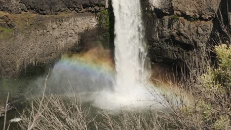 rainbow forms in mist below palouse waterfall in eastern washington