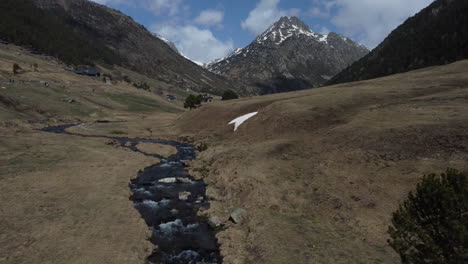 Beautiful-natural-valley-with-sun-scorched-grass-and-snowy-mountain-tops