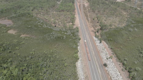directly-above-drone-shot-of-truck-driving-on-a-road-in-Northern-Territory,-Outback-Australia