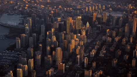 golden hour aerial view of downtown vancouver city, sunlit skyscrapers