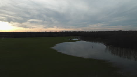 Loosahatchie-river-at-sunset-with-serene-waters-and-forest,-aerial-view