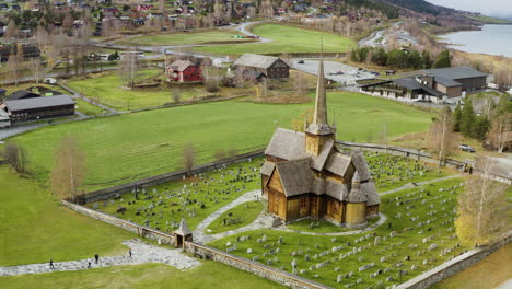 scenic view on lom stavkyrkje - lom stave church in norway during autumn - aerial drone shot