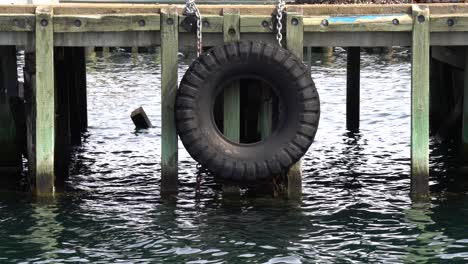 a sizeable tire in a port to prevent boats from damaging the platform with waves moving around