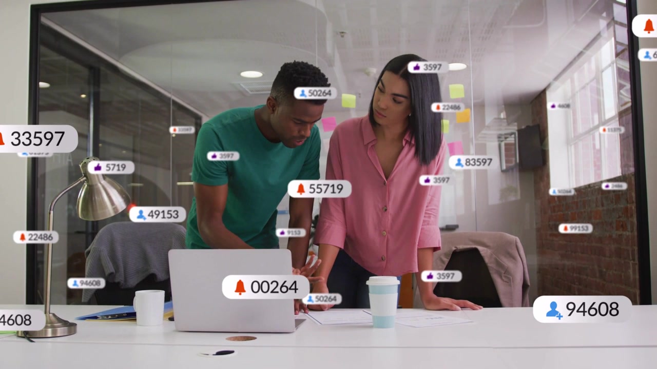 Two coworkers leaning over laptop man tapping phone causing alerts rising across glass for business