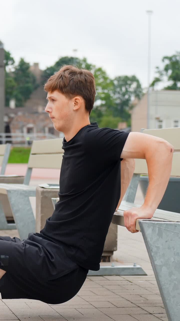 Vertical View Of Caucasian Man Doing Bench Dips Exercise