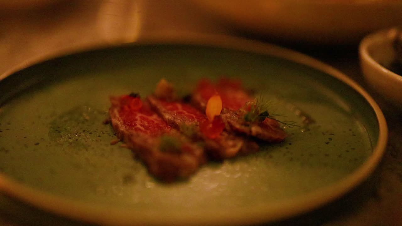 Slicing and serving beef tataki dish