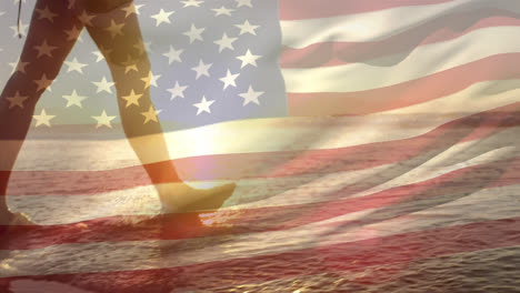 woman walking by the beach and the american flag for fourth of july.