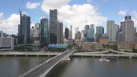 aerial rising from brisbane river, cbd in background, brisbane, australia