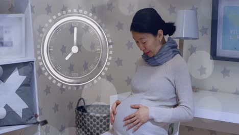 fast moving clock and bokeh lights over happy a pregnant asian woman rubbing belly