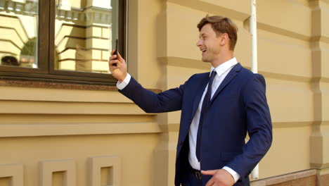 successful businessman having video call outdoors