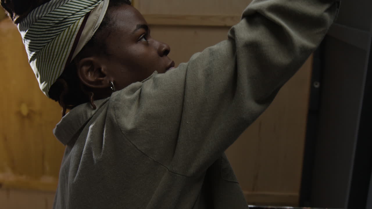 A woman painting a wall