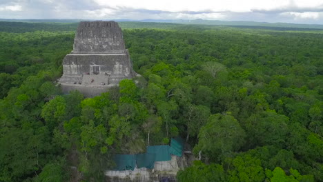 spectacular aerial shot over the treetops and tikal pyramids in guatemala 4