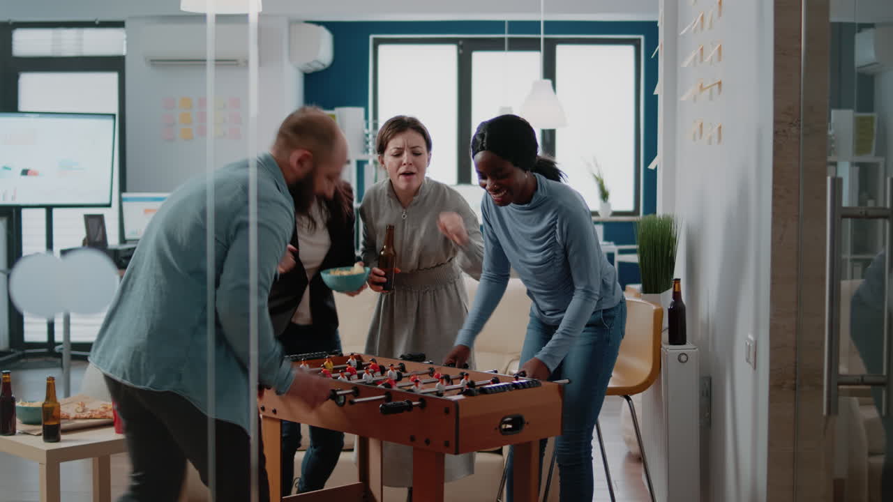 Frustrated man losing foosball game having fun after work
