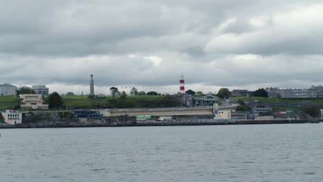lighthouse plymouth england on boat moody cloudy sky