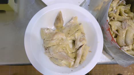 putting chopped duck meat in a bowl for serving - top view