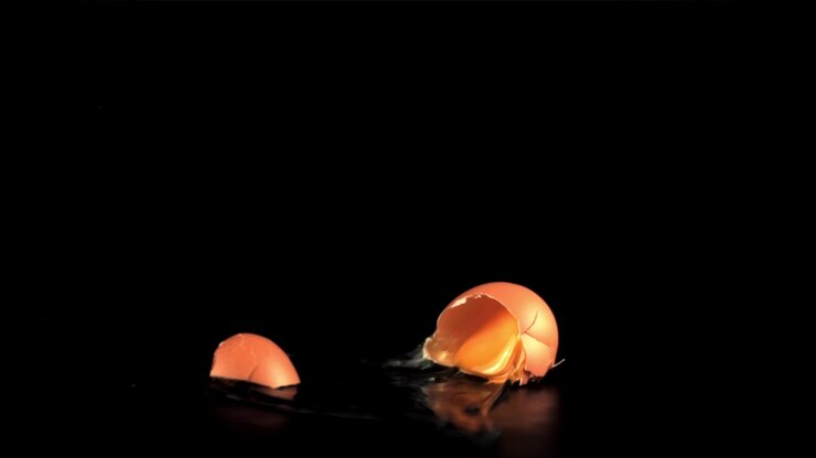 Egg Breaking in Slow Motion on a Black Background