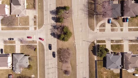 Vehicles-Driving-At-Metro-Parkway-Between-Houses-In-Sterling-Heights-In-Macomb-County,-Michigan,-USA