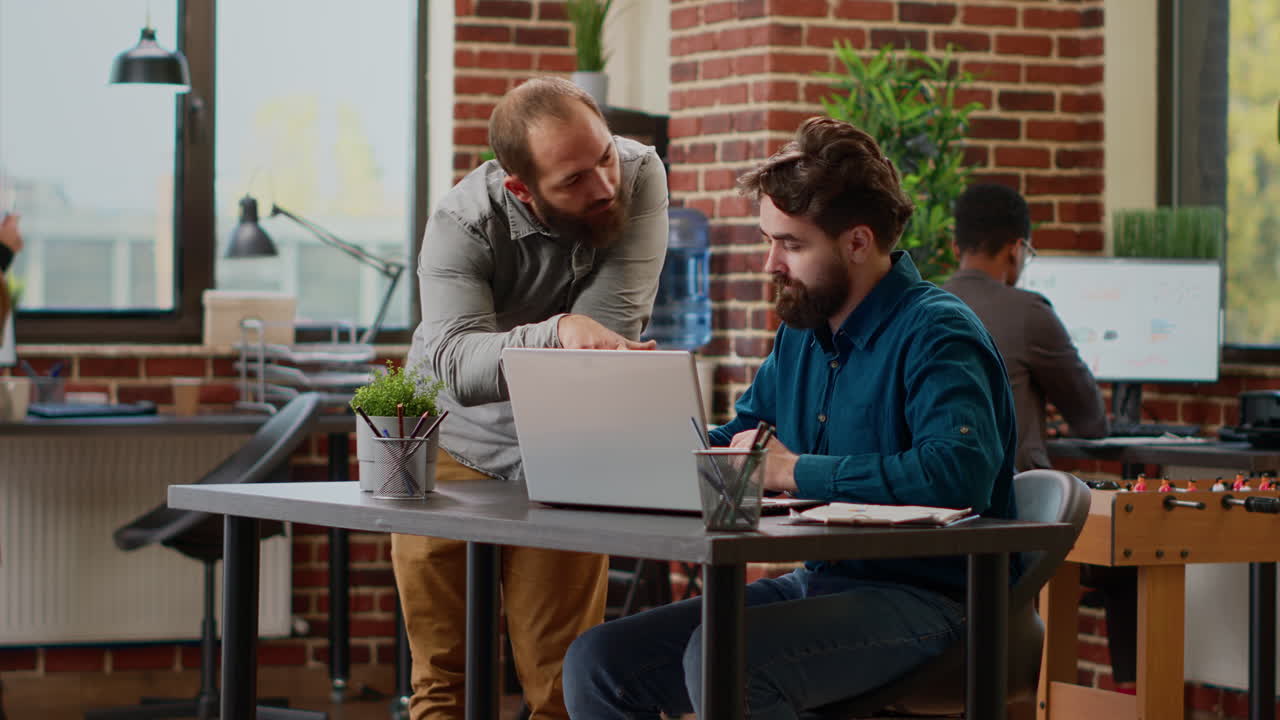Team of office coworkers planning business report on laptop